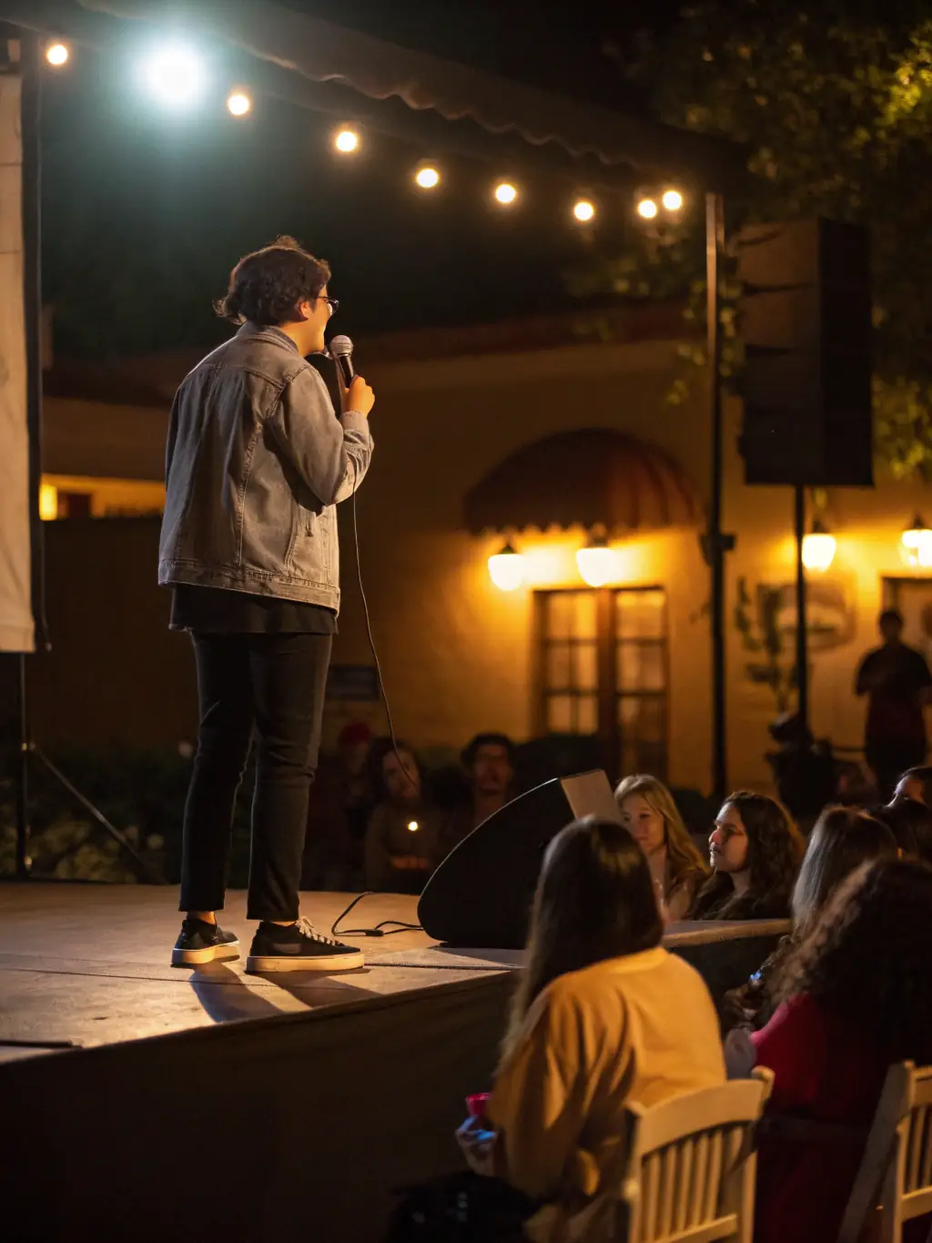 An image showing a community gathering during a storytelling event, with a focus on the expressive storyteller and the engaged audience.