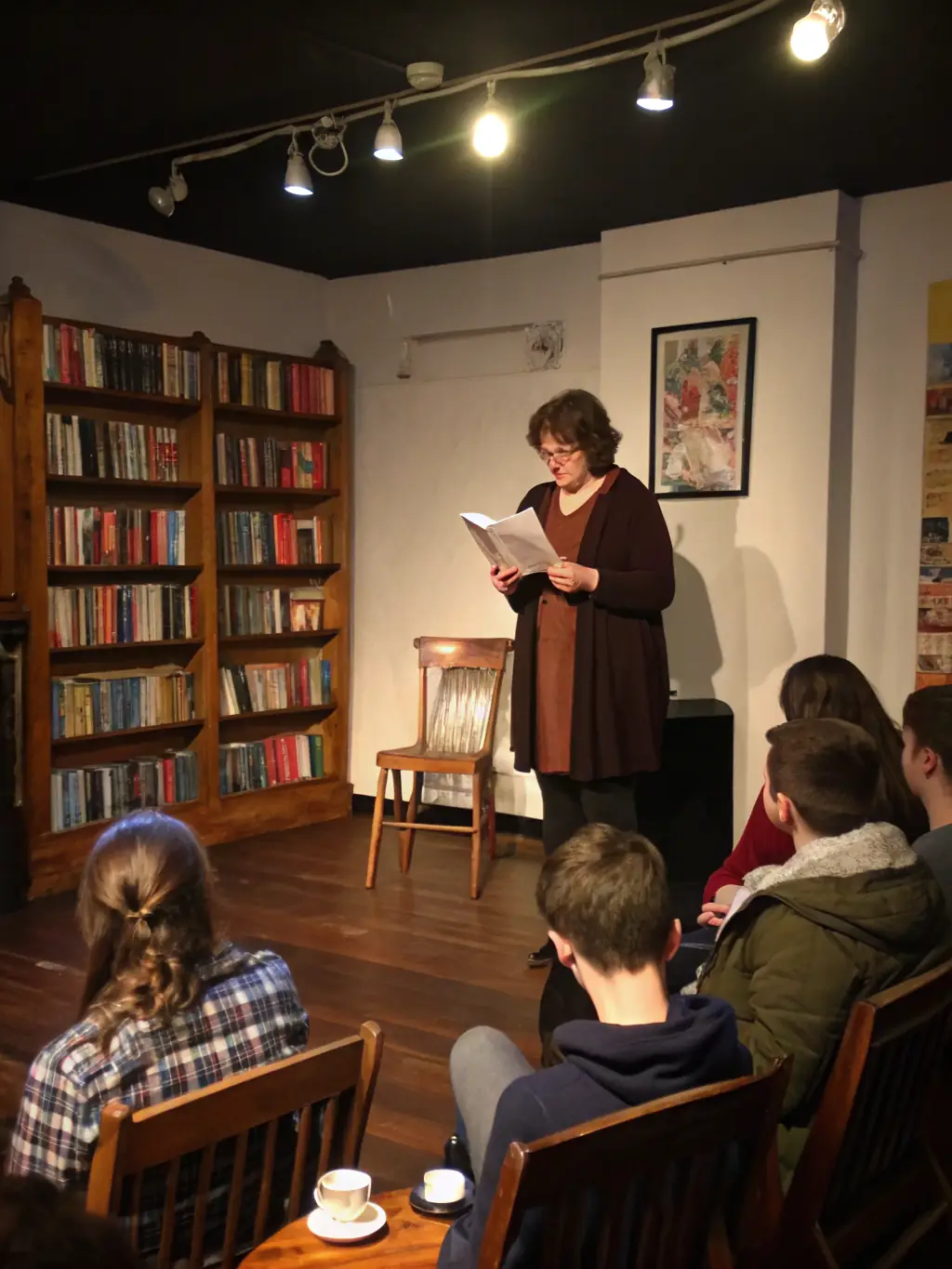 A visually appealing image of a literary event, featuring a book reading by a local author, with attendees actively listening and engaging in discussions.